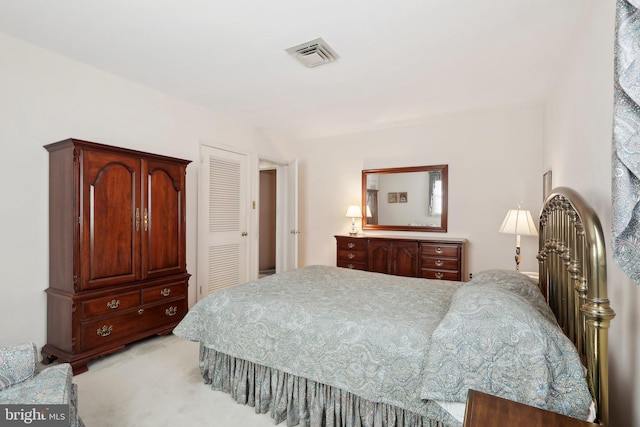 bedroom featuring a closet and light colored carpet