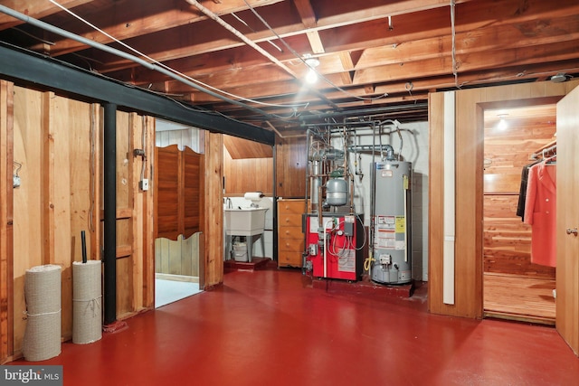 basement with water heater and wooden walls