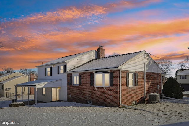 back house at dusk featuring central air condition unit