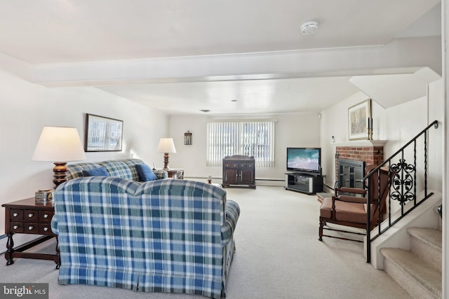 living room featuring carpet, a baseboard radiator, and a brick fireplace