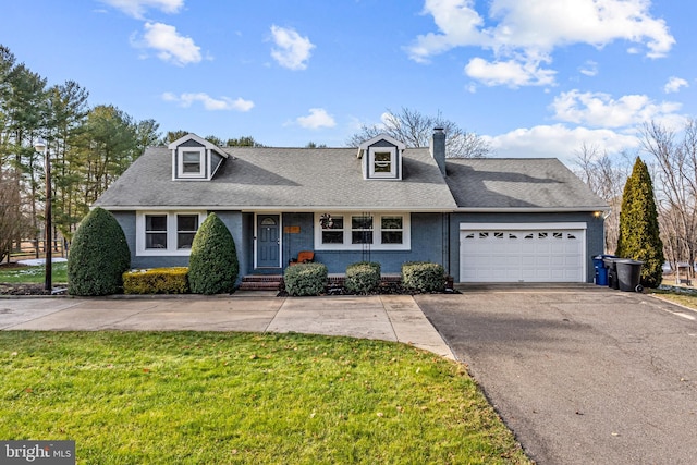 view of front of home with a front yard and a garage