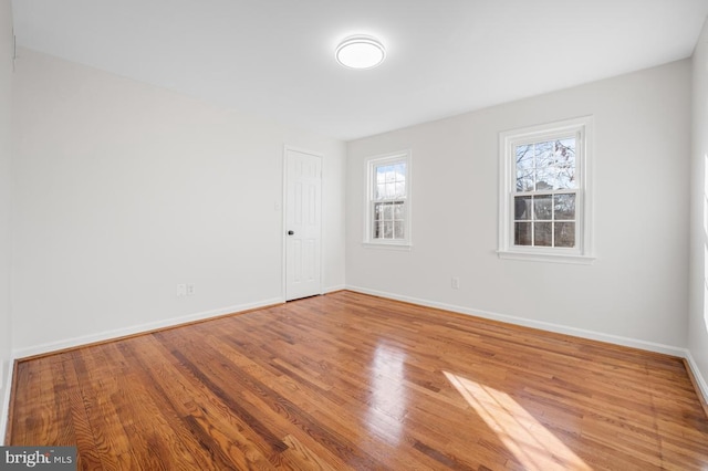 empty room with hardwood / wood-style floors