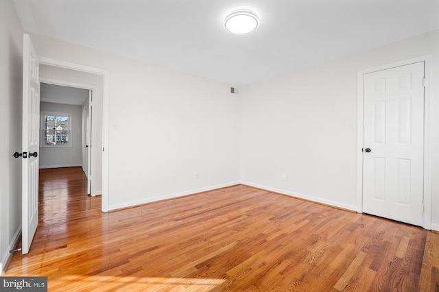 empty room with hardwood / wood-style floors