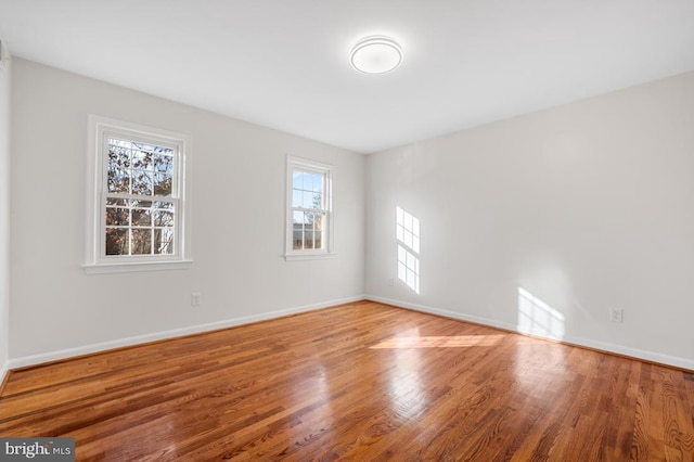 empty room with hardwood / wood-style floors