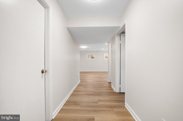 hall with light hardwood / wood-style flooring