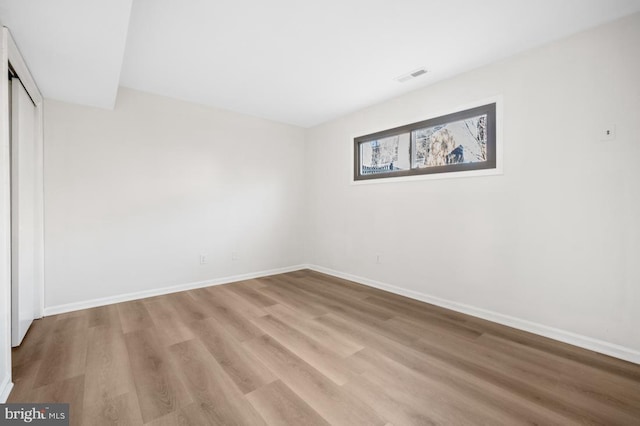 unfurnished bedroom with light wood-type flooring and a closet