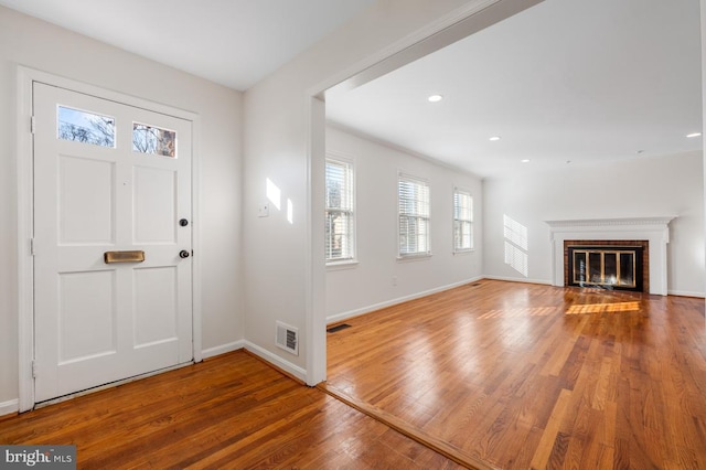 entryway featuring a fireplace and hardwood / wood-style floors