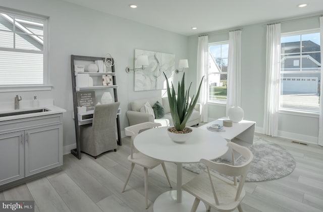 dining area featuring light hardwood / wood-style flooring and sink