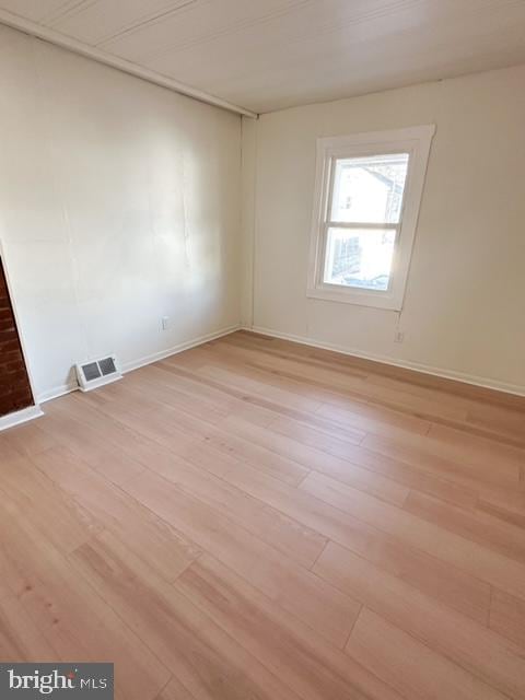 unfurnished room with light wood-type flooring