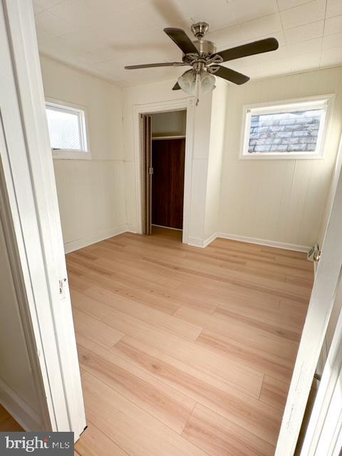 unfurnished room with ceiling fan and light hardwood / wood-style flooring