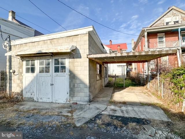 back of property with a carport