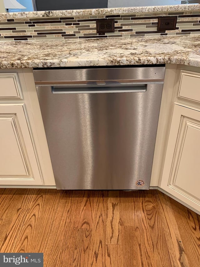 interior details with light stone countertops and dishwasher