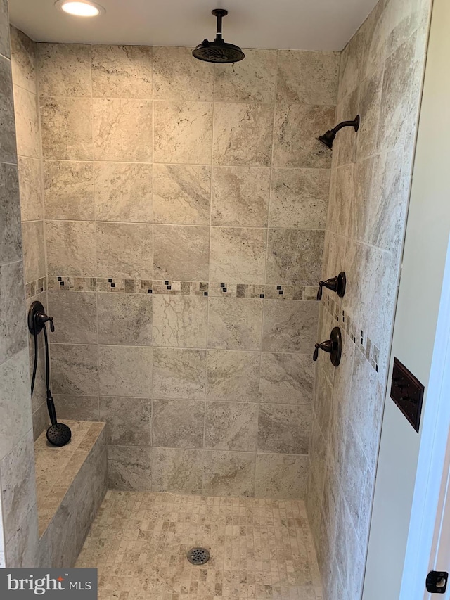 bathroom with tiled shower