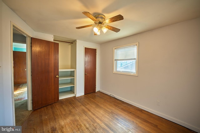 unfurnished bedroom featuring ceiling fan and hardwood / wood-style flooring