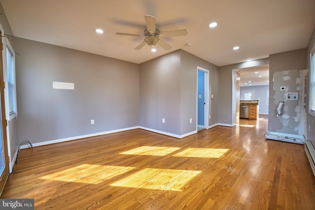 unfurnished living room featuring ceiling fan and wood-type flooring