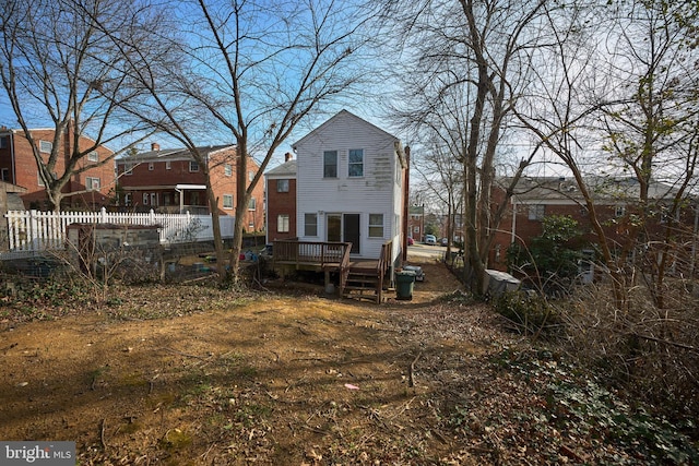 rear view of house featuring a deck