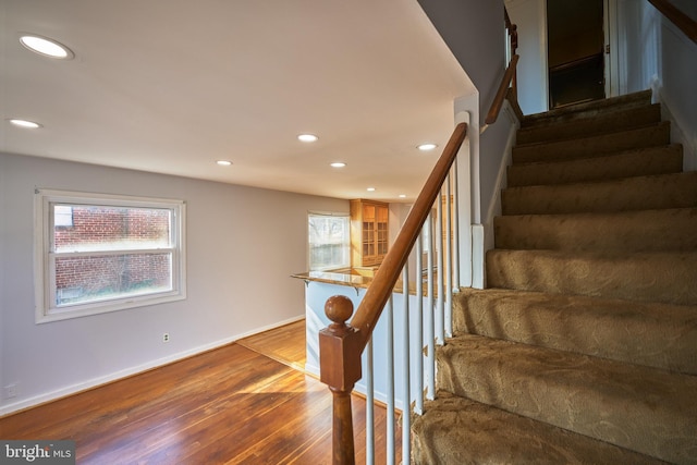 staircase with hardwood / wood-style flooring