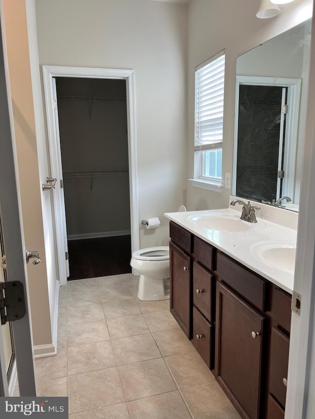 bathroom with tile patterned floors, vanity, and toilet