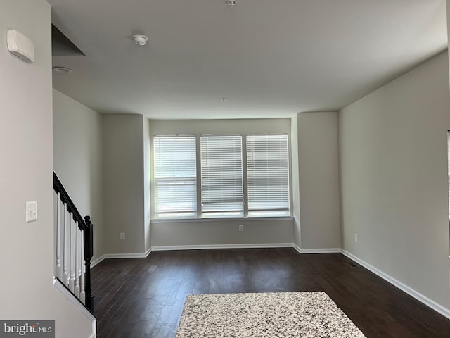 empty room featuring dark hardwood / wood-style flooring