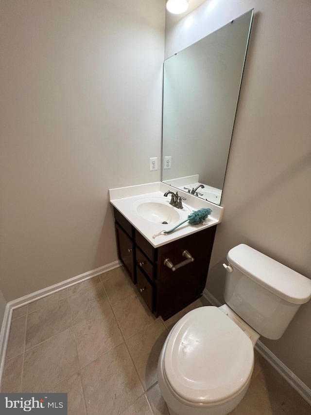 bathroom featuring tile patterned flooring, vanity, and toilet