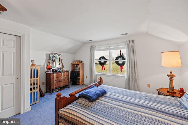 carpeted bedroom with vaulted ceiling