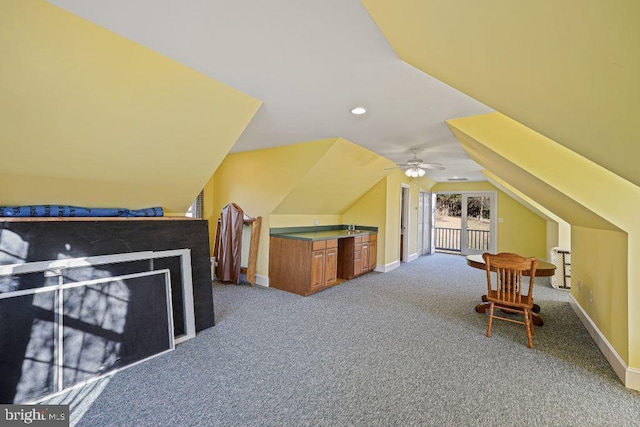 additional living space with carpet, ceiling fan, and lofted ceiling