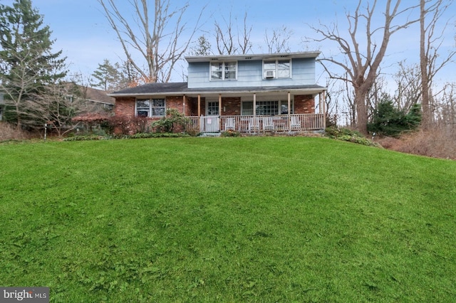 view of front of home with covered porch and a front yard