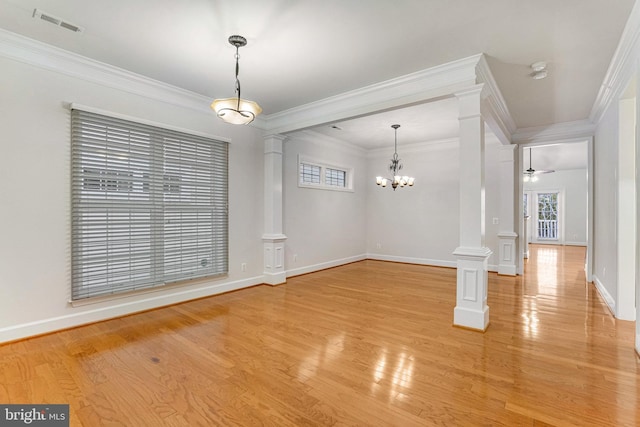 unfurnished dining area featuring visible vents, light wood-type flooring, ornate columns, and ornamental molding