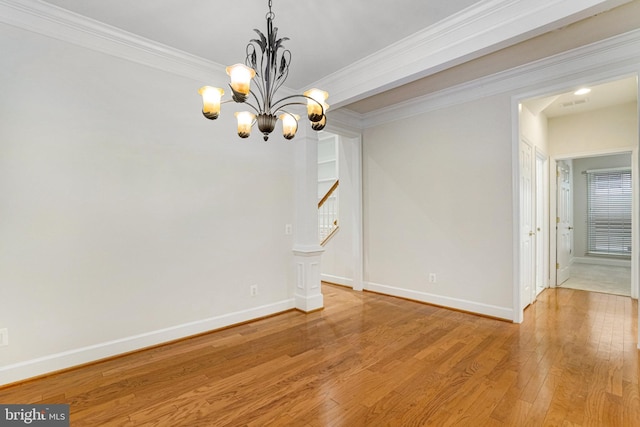 unfurnished dining area with baseboards, light wood finished floors, stairs, crown molding, and a notable chandelier