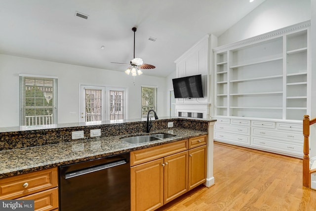 kitchen with visible vents, lofted ceiling, ceiling fan, a sink, and black dishwasher