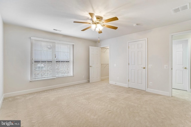 unfurnished bedroom with visible vents, baseboards, ceiling fan, and carpet flooring