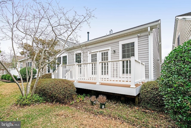 rear view of property featuring a deck