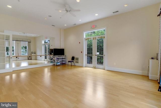 interior space with visible vents, french doors, ceiling fan, and wood finished floors