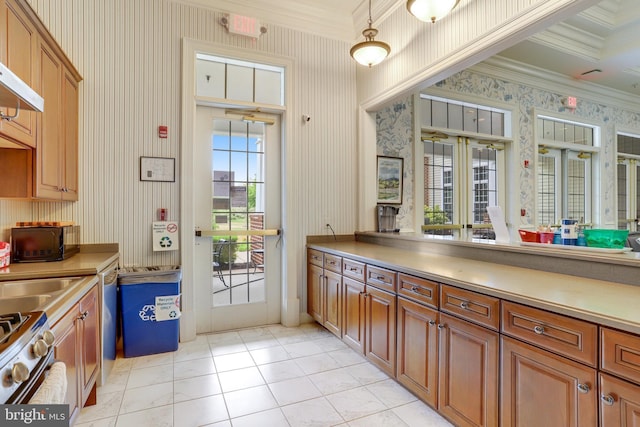 kitchen featuring wallpapered walls, crown molding, light countertops, and appliances with stainless steel finishes