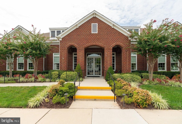 view of front of property featuring french doors and brick siding