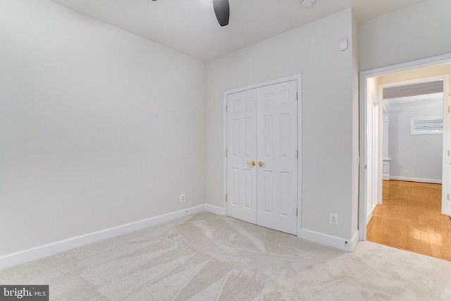 unfurnished bedroom featuring a closet, ceiling fan, baseboards, and carpet floors