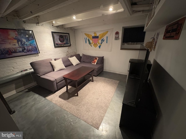 living room with concrete flooring and beam ceiling