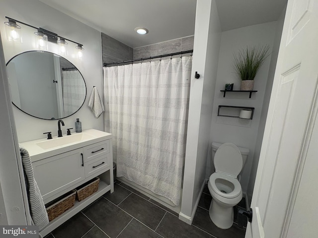 bathroom featuring tile patterned flooring, vanity, and toilet