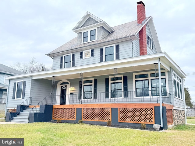 view of front facade with a porch and a front lawn