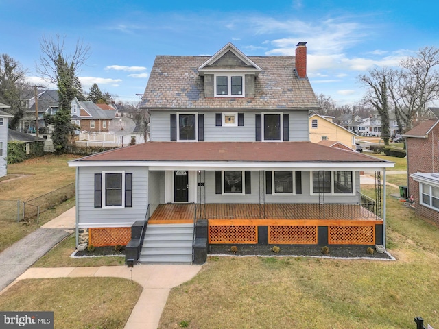 view of front of property featuring a front lawn and a porch