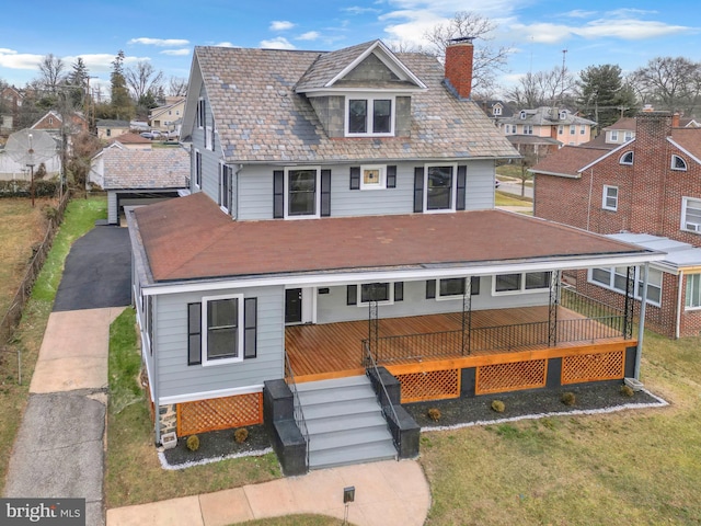 view of front of house featuring a front yard and a wooden deck