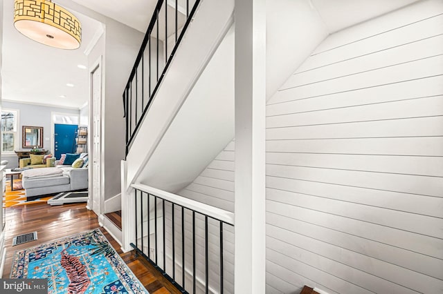 stairs with wood-type flooring and lofted ceiling