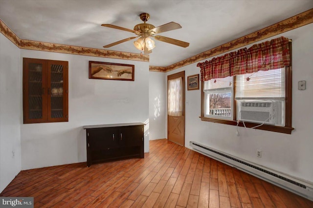 unfurnished room with ceiling fan, cooling unit, a baseboard radiator, and hardwood / wood-style flooring