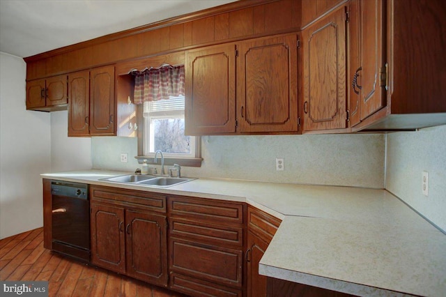 kitchen featuring sink, black dishwasher, and light hardwood / wood-style flooring