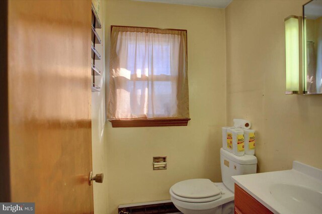 bathroom featuring a baseboard radiator, vanity, and toilet