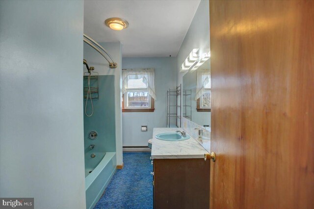 bathroom featuring tub / shower combination, a baseboard radiator, and vanity