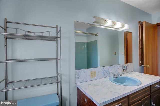 bathroom featuring vanity and a shower