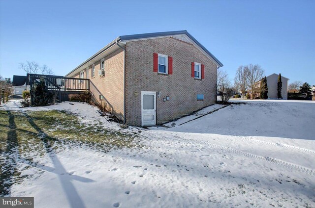 view of snow covered exterior featuring a deck