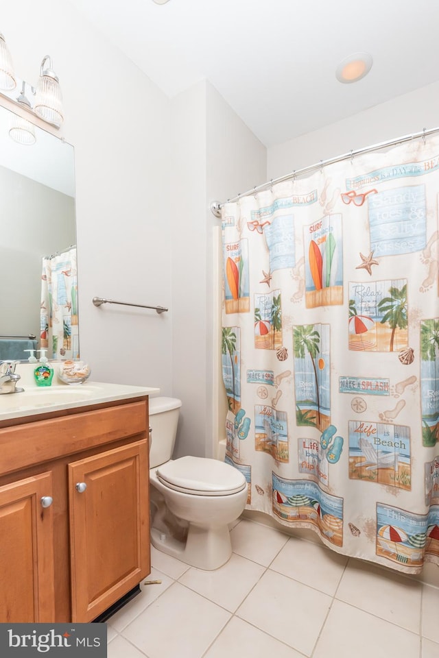 bathroom with a shower with curtain, vanity, toilet, and tile patterned flooring