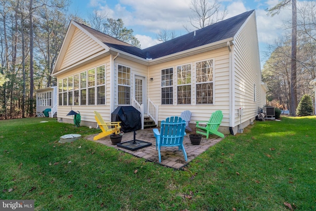 back of property featuring a yard, a sunroom, a patio, and central air condition unit